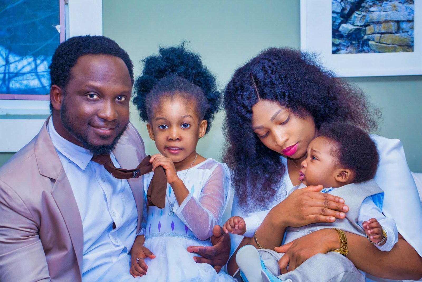 Parents at home with their daughter and baby son